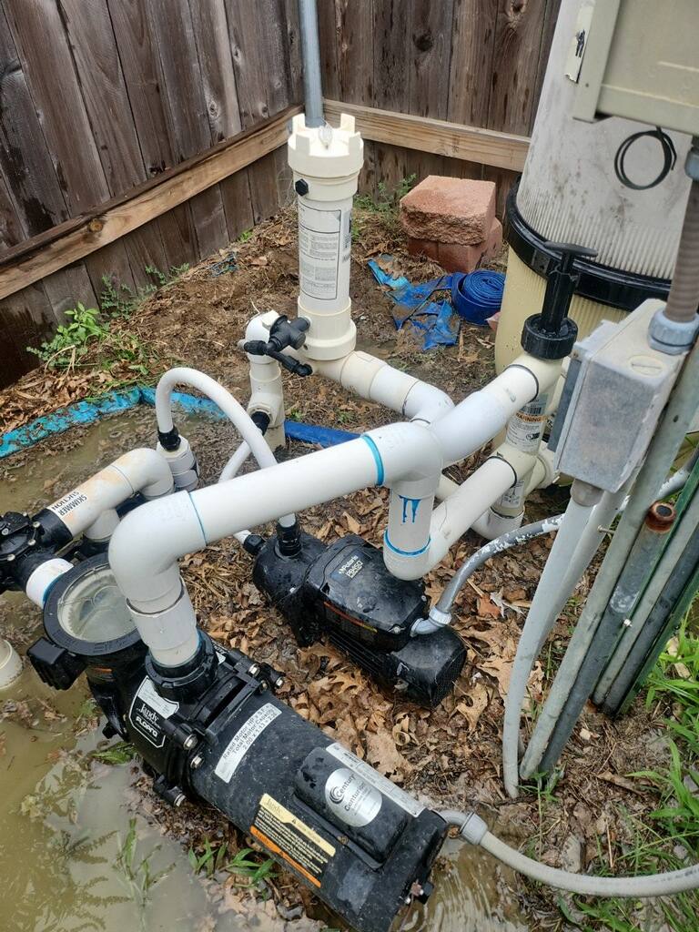 Pool pump and filter plumbing on an equipment pad